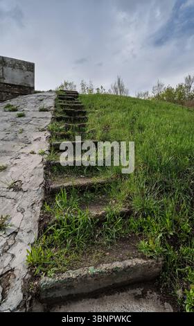 Big broken stairs in the the park made from concrete. Old broken concrete steps. Outdoor dangerous broken house steps Stock Photo