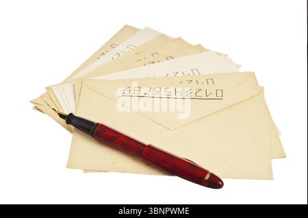 Stack of mail envelopes and a pen isolated on white background Stock Photo