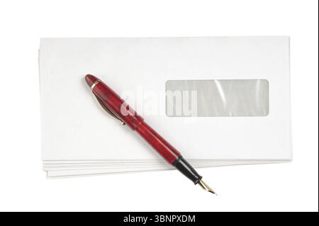 Stack of mail envelopes and a pen isolated on white background Stock Photo