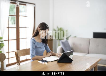 Happy Confident young asian businesswoman working with tablet Start up small business owner. business successful technology concept Stock Photo