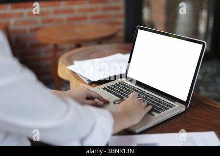 Woman with blank white screen laptop, Mockup image blank white desktop screen Stock Photo