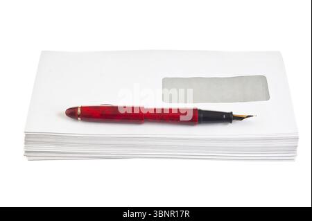 Stack of mail envelopes and a pen isolated on white background Stock Photo