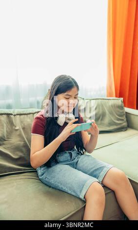 Asian girl from Generation Z in pink sunglasses and casual attire poses ...
