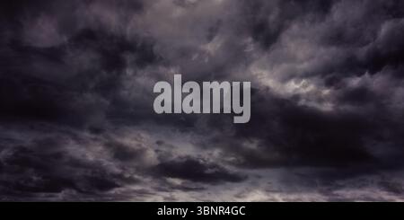 Storm cloud layers are dominating flat design sky, showing dense gray storm textures Stock Photo