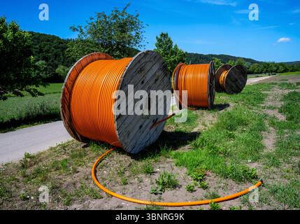 Construction site with a fiber optic cable roll for digital broadband internet communication. Stock Photo