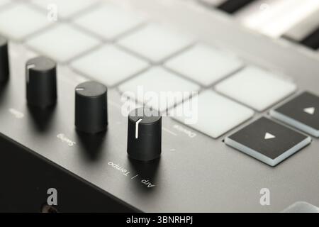 MIDI keyboard with buttons and faders, closeup Stock Photo