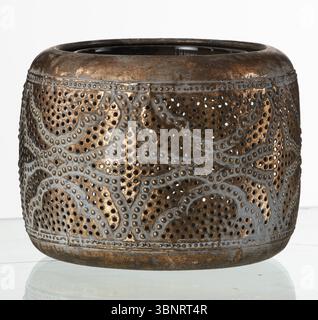 Antique copper perforated metal jar isolated nature background with clipping path Stock Photo