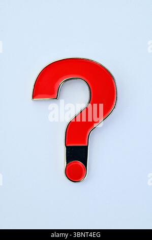 Badge or pin or sign  simply a red question mark on plain background Stock Photo