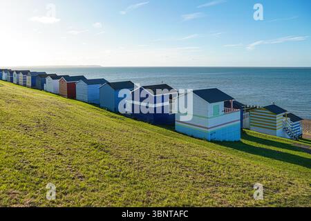 Colourful traditional wooden beach huts at Whitstable beach, Kent, England United Kingdom UK Stock Photo