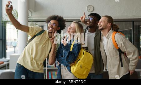 Multiracial diversity students friends talking in school university college corridor influencer guy African American man make photo picture selfie Stock Photo