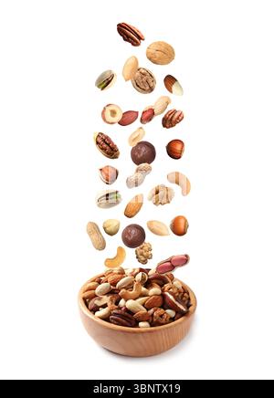 Peanut and other nuts falling into bowl on white background Stock Photo