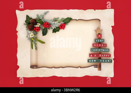 Christmas paper scroll on parchment paper on red, vintage tree decoration, nature flora of holly, winter flora. Festive old fashioned retro design. Stock Photo