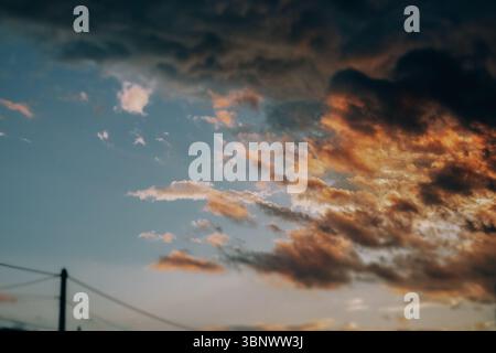 The sky ablaze with sunset colors, creating a beautiful and captivating vista of nature. A view of a partly cloudy sky at sunset, the clouds Stock Photo