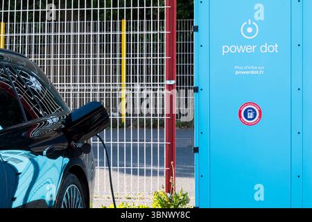 A car charging at a Power dot recharging point in France. Stock Photo