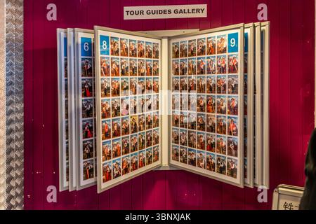 Photo gallery featuring foreign tour guides on the Titlis wearing traditional Swiss costumes at the Titlis mountain station. A "Tour Guides Gallery" presents photos of tourist guides, often posing in traditional dress with instruments or hiking poles against an alpine backdrop. This exhibition serves to introduce visitors to the local guides in the Titlis area in Engelberg, Obwalden, Switzerland Stock Photo