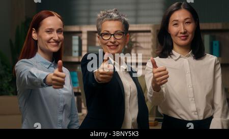 Caucasian Asian Korean multiethnic women showing thumbs up recommend office females successful feedback good diversity team gesture businesswomen Stock Photo