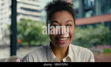 Close up face African American woman toothy dental smile laughter enjoy excited looking at camera expression entrepreneur employee female Stock Photo