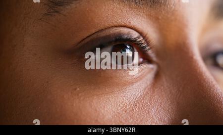 Close up eye face African American woman female girl businesswoman mascara eyelashes portrait detail vision eyesight make-up sight see looking Stock Photo