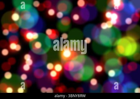 Multicolored blurred light circles are floating over black backdrop in digital bokeh pattern Stock Photo