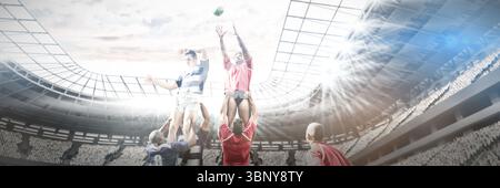 Low angle view of multiracial players carrying teammates on shoulders and chasing ball in stadium Stock Photo