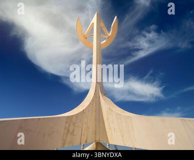 Symmetrical low-angle view of the Montjuïc Communications Tower by Santiago Calatrava, against a beautiful sky with clouds, Barcelona, Spain. Stock Photo
