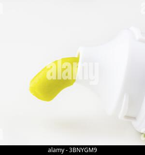 Green toothpaste is squeezed out of a tube of toothpaste on a white background close-up Stock Photo