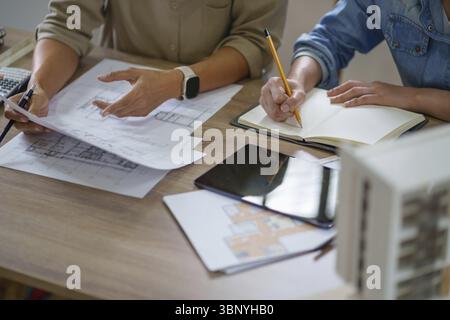 Architects interior designer hands working with Blue prints and documents for a home renovation for house design Stock Photo
