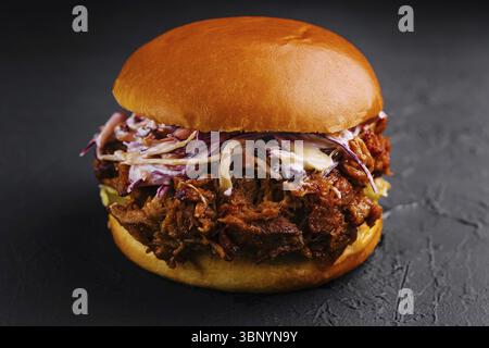food still-life, Pulled pork sandwich on black stone Stock Photo