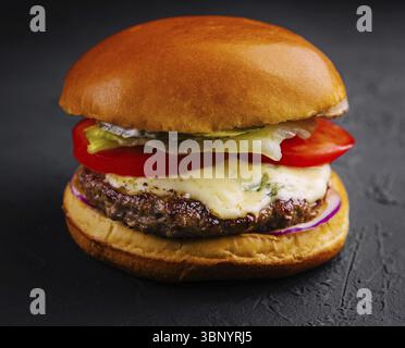 food still-life, Delicious cheeseburger on a black background Stock Photo
