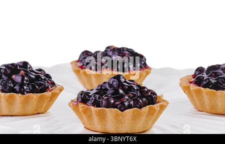 Small cakes with currant on white big plate Stock Photo