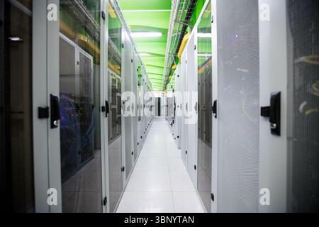 Flat design is showing empty central aisle in data center with racks, cable trays and tiles Stock Photo