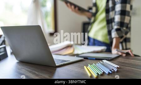 Creative designer using digital tablet creating artwork at modern workplace Stock Photo