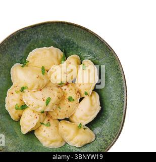 Dumplings with cottage cheese on a green plate isolated Stock Photo