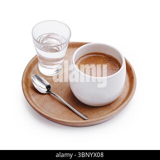 food still-life, A rich hot beverage is presented in a white cup alongside a clear glass of water on a wooden tray. A stainless steel spoon rests near Stock Photo