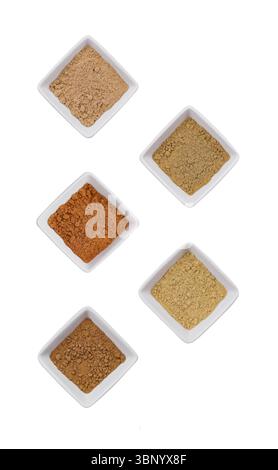 Various Indian Spices in Small White Bowls on white background Stock Photo