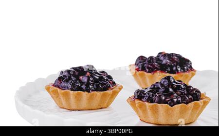 Small cakes with currant on white big plate Stock Photo