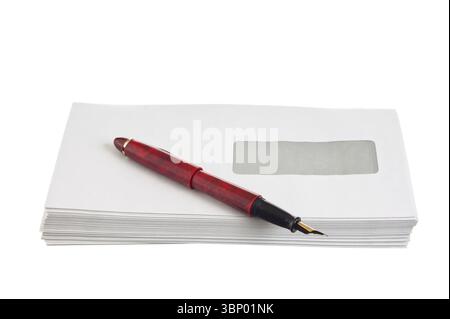 Stack of mail envelopes and a pen isolated on white background Stock Photo