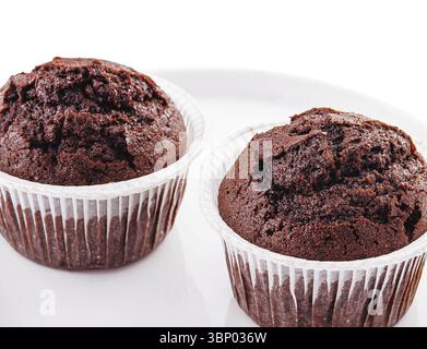 food still-life, Chocolate cupcakes on a plate isolated on white Stock Photo