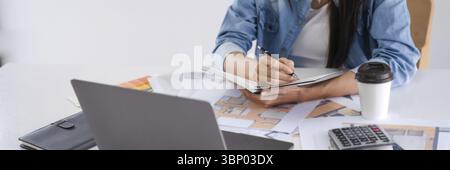 Confident working woman Asian Architects designer construction plans on blueprint Stock Photo