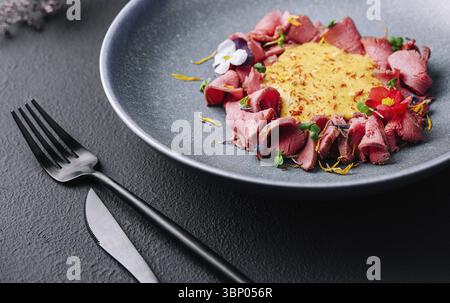 food still-life, Ham in cheese sauce on plate Stock Photo
