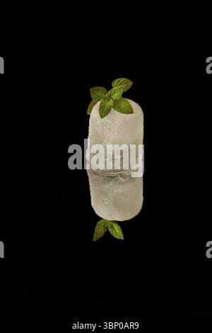 Melting ice on black surface Stock Photo - Alamy