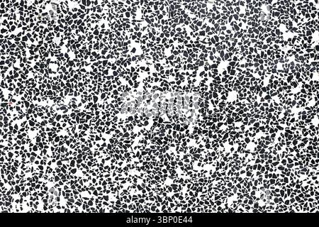 Black and white terrazzo surface. Irregular stone chips pattern. Minimalist flooring or wall texture. Abstract decorative background. Modern design. Stock Photo
