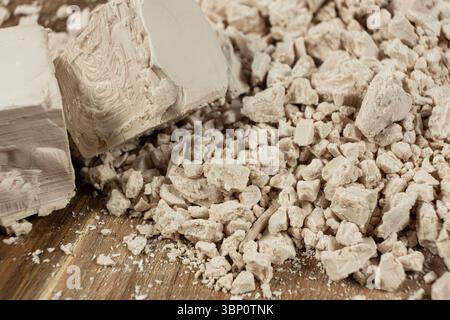 Compressed fresh yeast cubes close-up on a wooden background Stock Photo