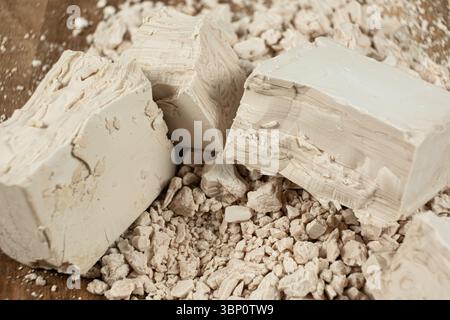 Compressed fresh yeast cubes close-up on a wooden background Stock Photo