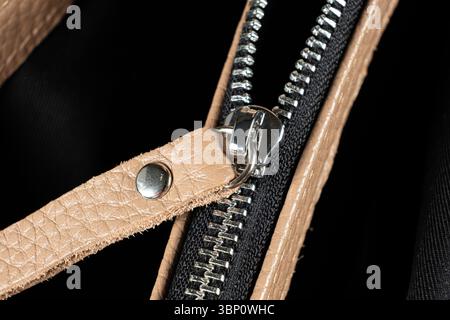 Metal zipper on the inside pocket of the leather bag Stock Photo