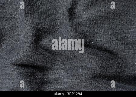 Old worn-out fabric with damaged structure, protruding threads Stock Photo