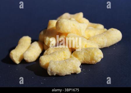 Delicious sweet corn sticks, isolated on dark blue background Stock Photo