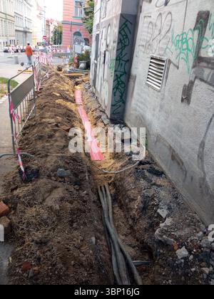 Laying a fiber optic cable for fast internet, Electricity and telephone cable along a street. Stock Photo