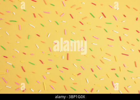 Colorful Sprinkle on Yellow Background, Rainbow Hagelslag Pattern Stock Photo