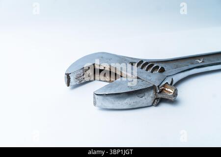 Close-up of a used adjustable wrench on white background. Perfect for tool, mechanic, repair, construction, or industrial design themes. Stock Photo